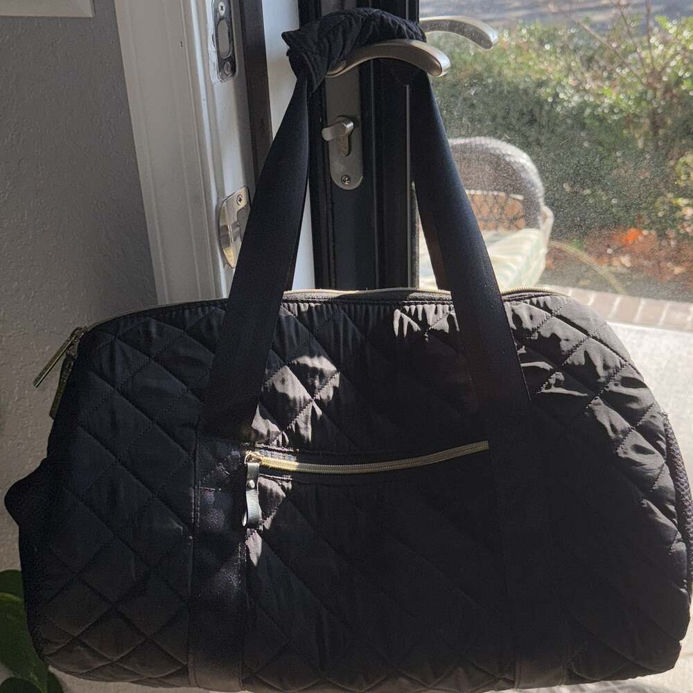 Cosmopolitan Black Quilted Duffel Bag With Gold Hardware and Blue Interior